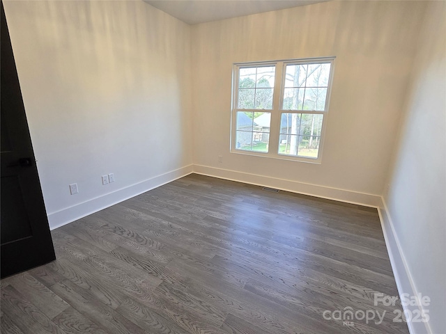 unfurnished room featuring dark hardwood / wood-style floors