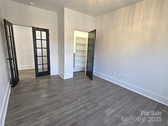 unfurnished bedroom featuring french doors, dark hardwood / wood-style floors, and a closet