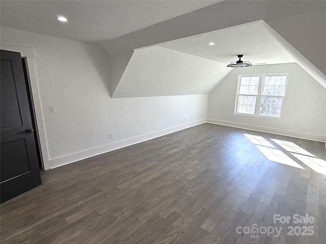 additional living space featuring lofted ceiling, dark hardwood / wood-style floors, and ceiling fan