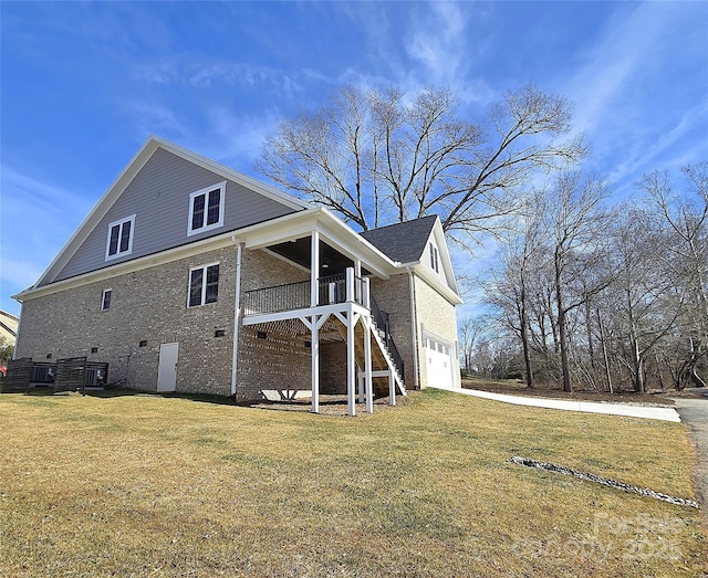 view of side of home featuring a garage and a lawn