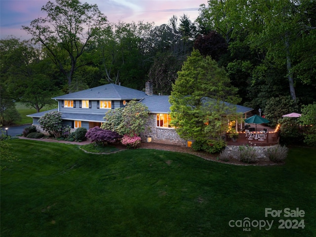 exterior space featuring a lawn and a deck