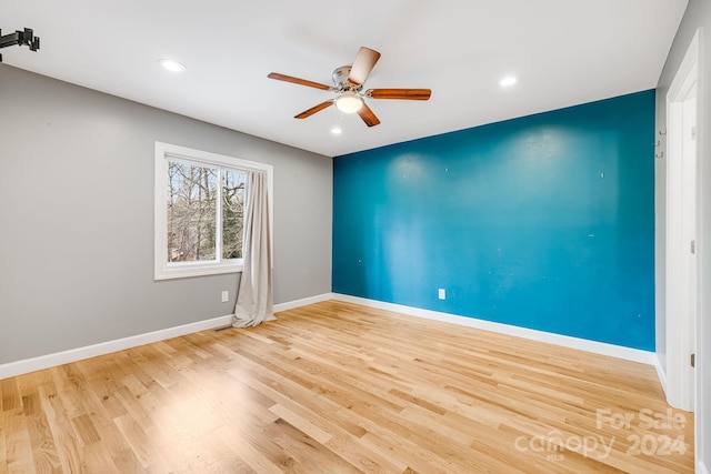 spare room with light hardwood / wood-style flooring and ceiling fan