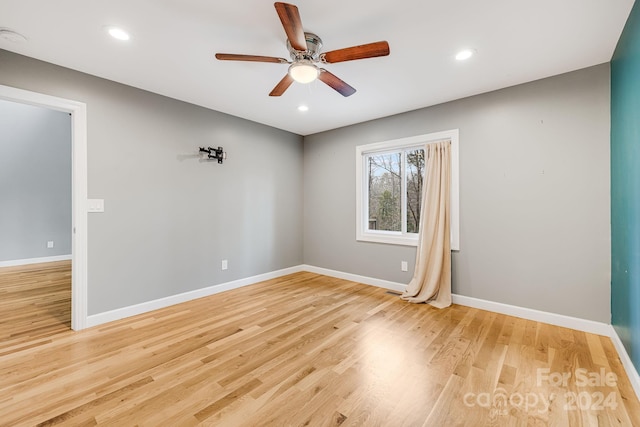 empty room featuring ceiling fan and light hardwood / wood-style flooring