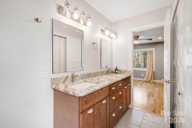 bathroom featuring ceiling fan, hardwood / wood-style floors, and vanity