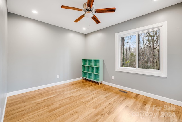 empty room with ceiling fan and light wood-type flooring