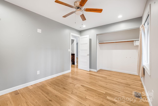 unfurnished bedroom featuring a closet, light hardwood / wood-style flooring, and ceiling fan