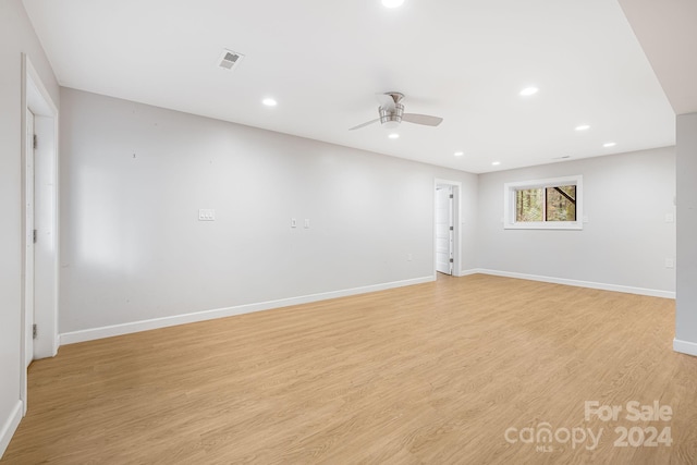 empty room featuring ceiling fan and light hardwood / wood-style floors