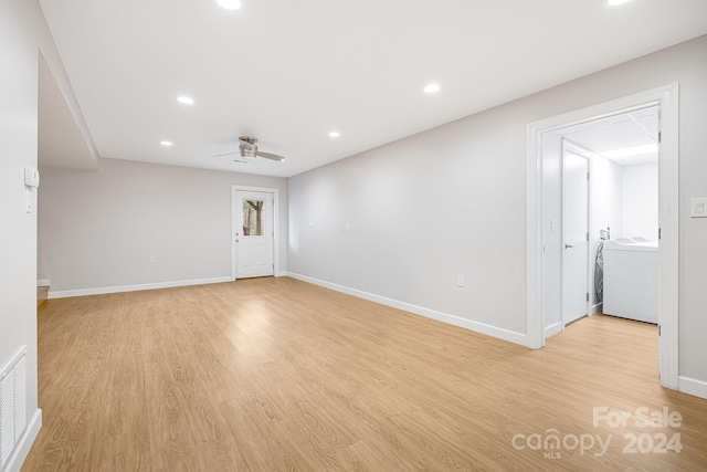 empty room featuring washer / dryer, light hardwood / wood-style flooring, and ceiling fan