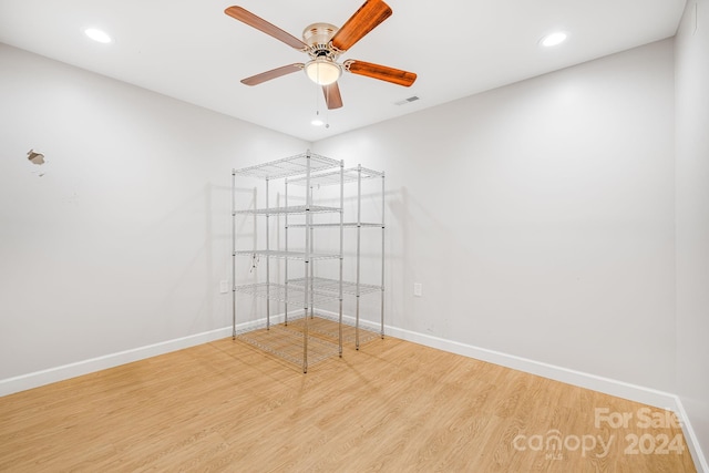 spare room with ceiling fan and hardwood / wood-style flooring