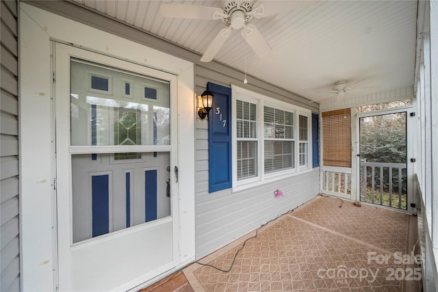 view of exterior entry with ceiling fan