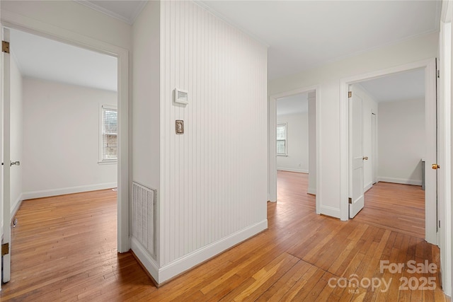 corridor featuring light hardwood / wood-style floors and a healthy amount of sunlight