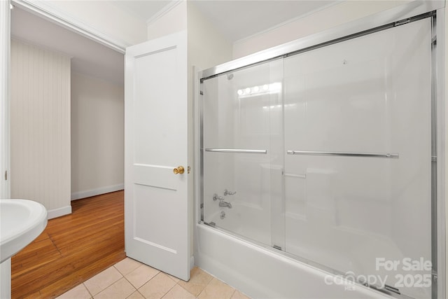 bathroom with combined bath / shower with glass door and tile patterned floors