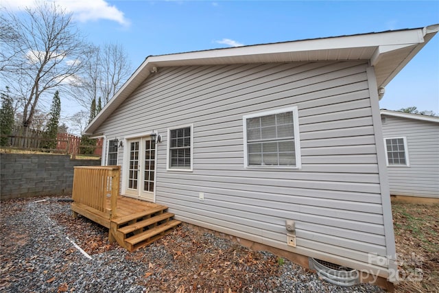 rear view of house featuring a wooden deck