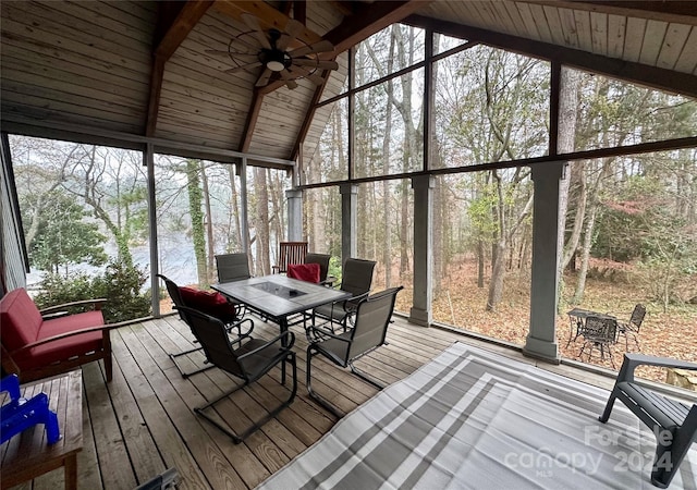 sunroom / solarium featuring vaulted ceiling with beams, ceiling fan, and wood ceiling