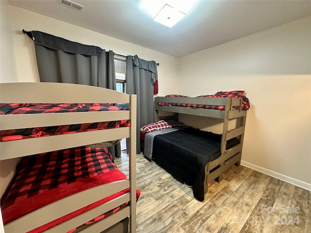 bedroom with hardwood / wood-style floors