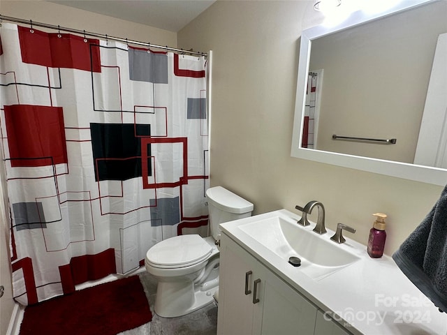 bathroom featuring vanity, toilet, and walk in shower