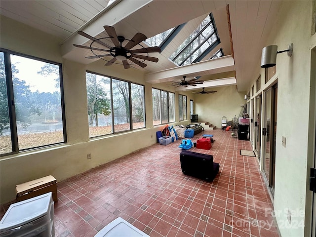 sunroom featuring lofted ceiling with skylight and plenty of natural light