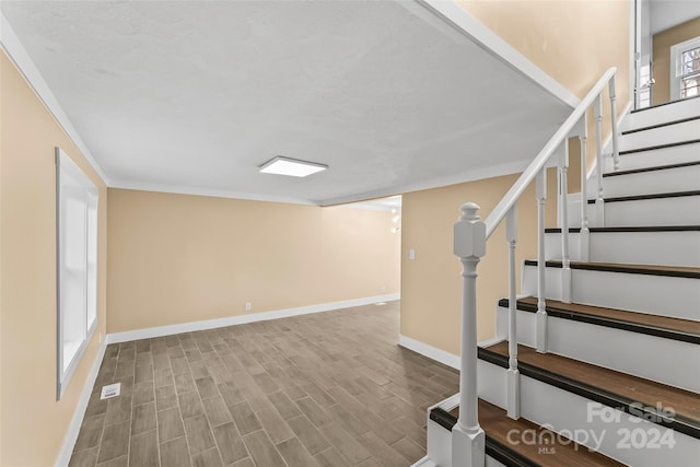 basement with plenty of natural light and ornamental molding