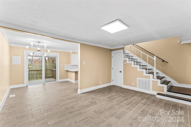 basement featuring crown molding and a notable chandelier