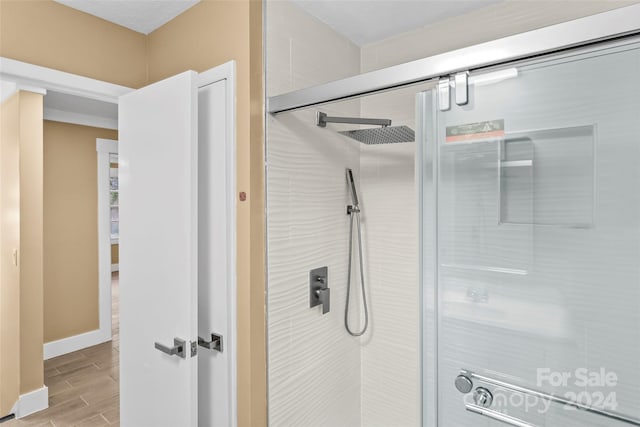 bathroom with a shower with shower door