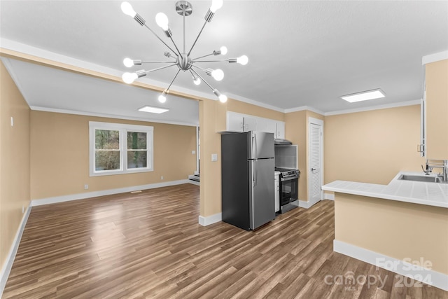 kitchen featuring sink, tile counters, hardwood / wood-style floors, white cabinets, and appliances with stainless steel finishes