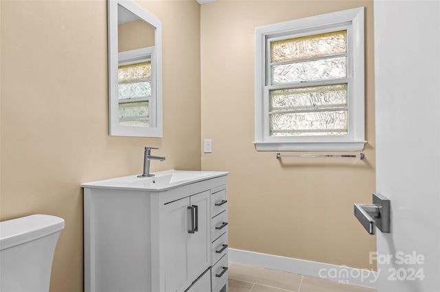 bathroom featuring tile patterned flooring, vanity, and toilet