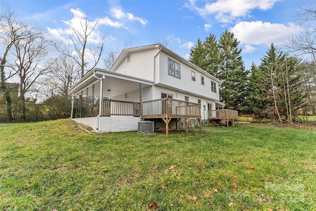 rear view of house featuring cooling unit, a yard, and a wooden deck