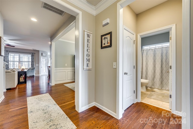 hall with crown molding and dark wood-type flooring