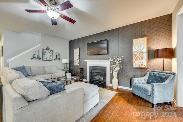 living room featuring wood-type flooring and ceiling fan