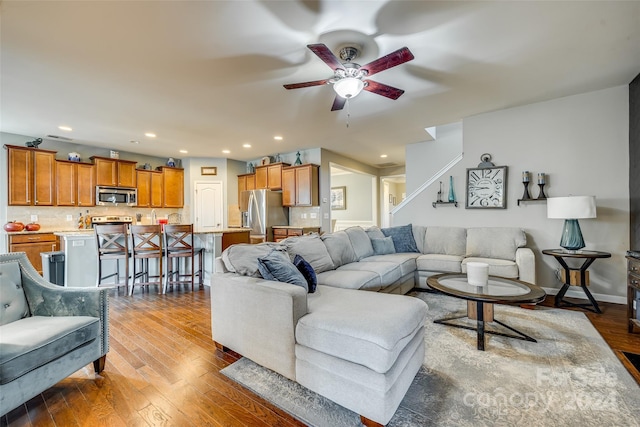 living room featuring hardwood / wood-style flooring and ceiling fan