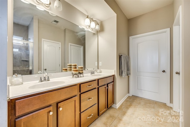 bathroom with tile patterned floors, a shower with door, and vanity