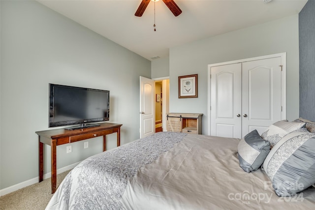 carpeted bedroom with a closet and ceiling fan