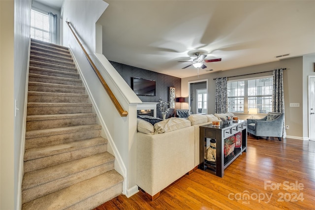 living room featuring ceiling fan, hardwood / wood-style floors, and plenty of natural light