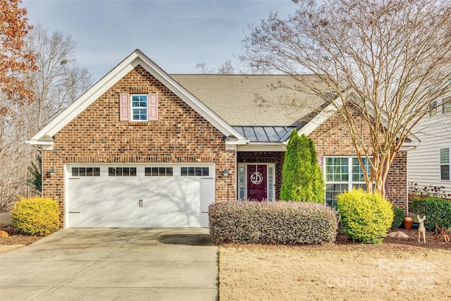 view of front of property featuring a standing seam roof, brick siding, metal roof, and concrete driveway