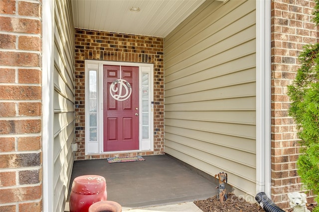 property entrance with brick siding