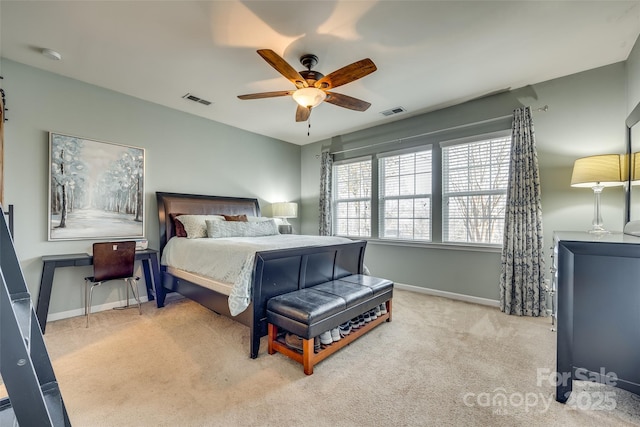 carpeted bedroom with visible vents, ceiling fan, and baseboards