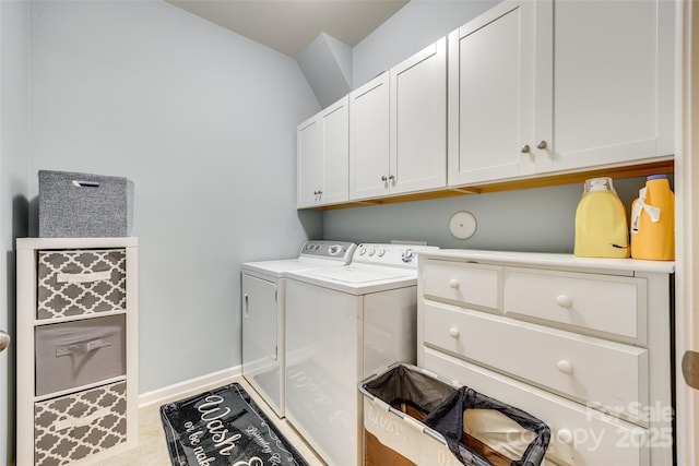 laundry room with independent washer and dryer, cabinet space, and baseboards