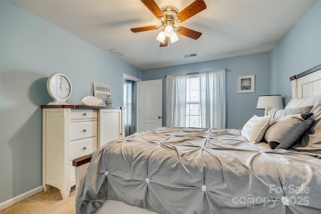 bedroom featuring baseboards, ceiling fan, visible vents, and light colored carpet