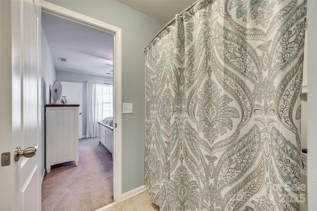 full bath featuring ensuite bathroom, visible vents, and baseboards