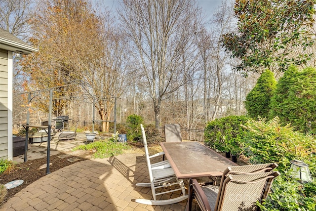 view of patio with outdoor dining space and fence