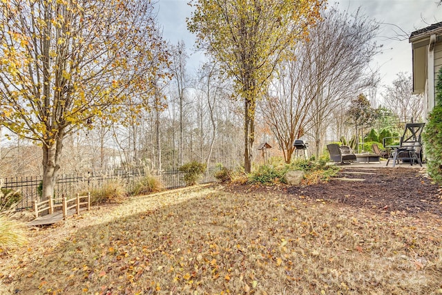 view of yard with fence and a patio