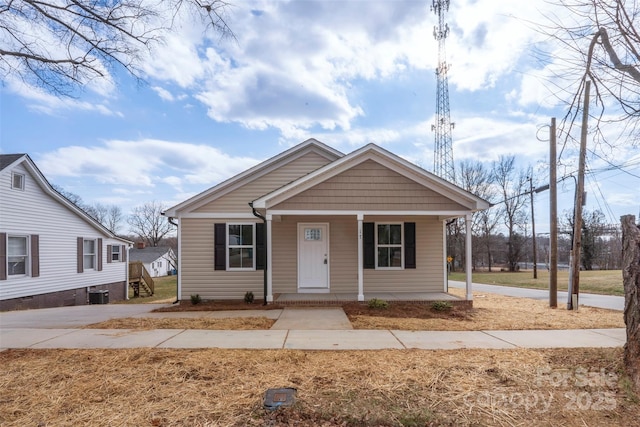 bungalow featuring a porch and central AC