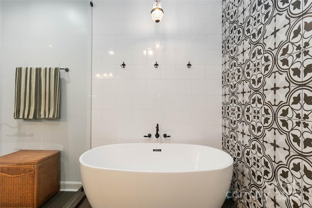 bathroom with a bathtub and tile walls