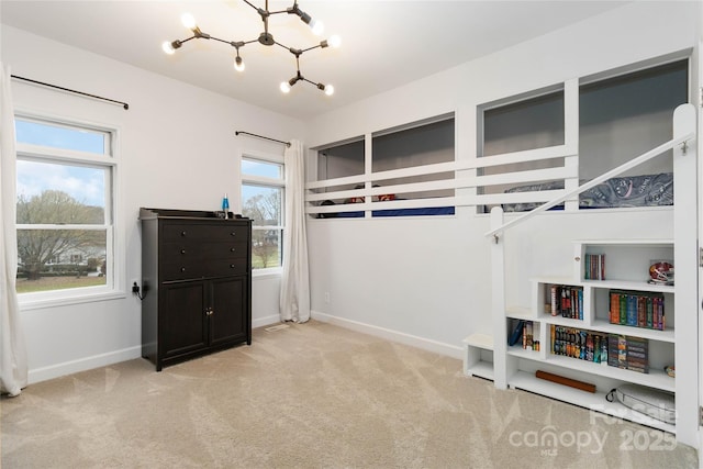 bedroom with an inviting chandelier and light carpet