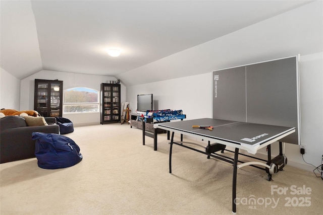 recreation room with lofted ceiling and carpet