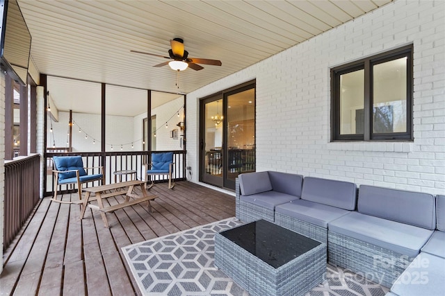 wooden terrace featuring ceiling fan and outdoor lounge area