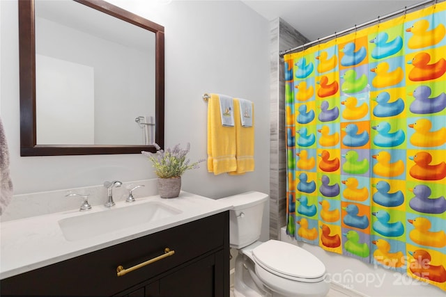 full bathroom with vanity, shower / bath combo with shower curtain, and toilet