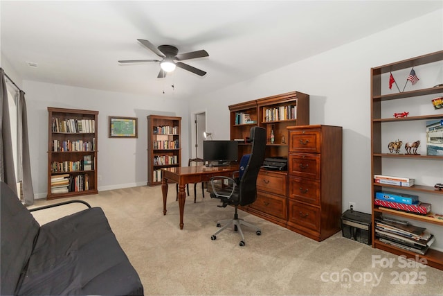 carpeted office featuring ceiling fan