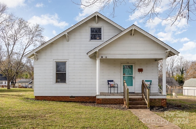 bungalow-style home with a porch and a front lawn