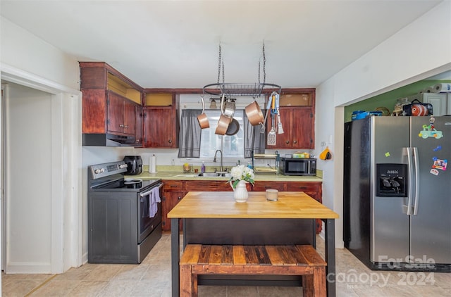 kitchen featuring light tile patterned floors, sink, and appliances with stainless steel finishes